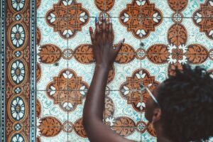 Black girl touching azulejo wall