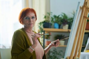 Elderly woman painting as art therapy